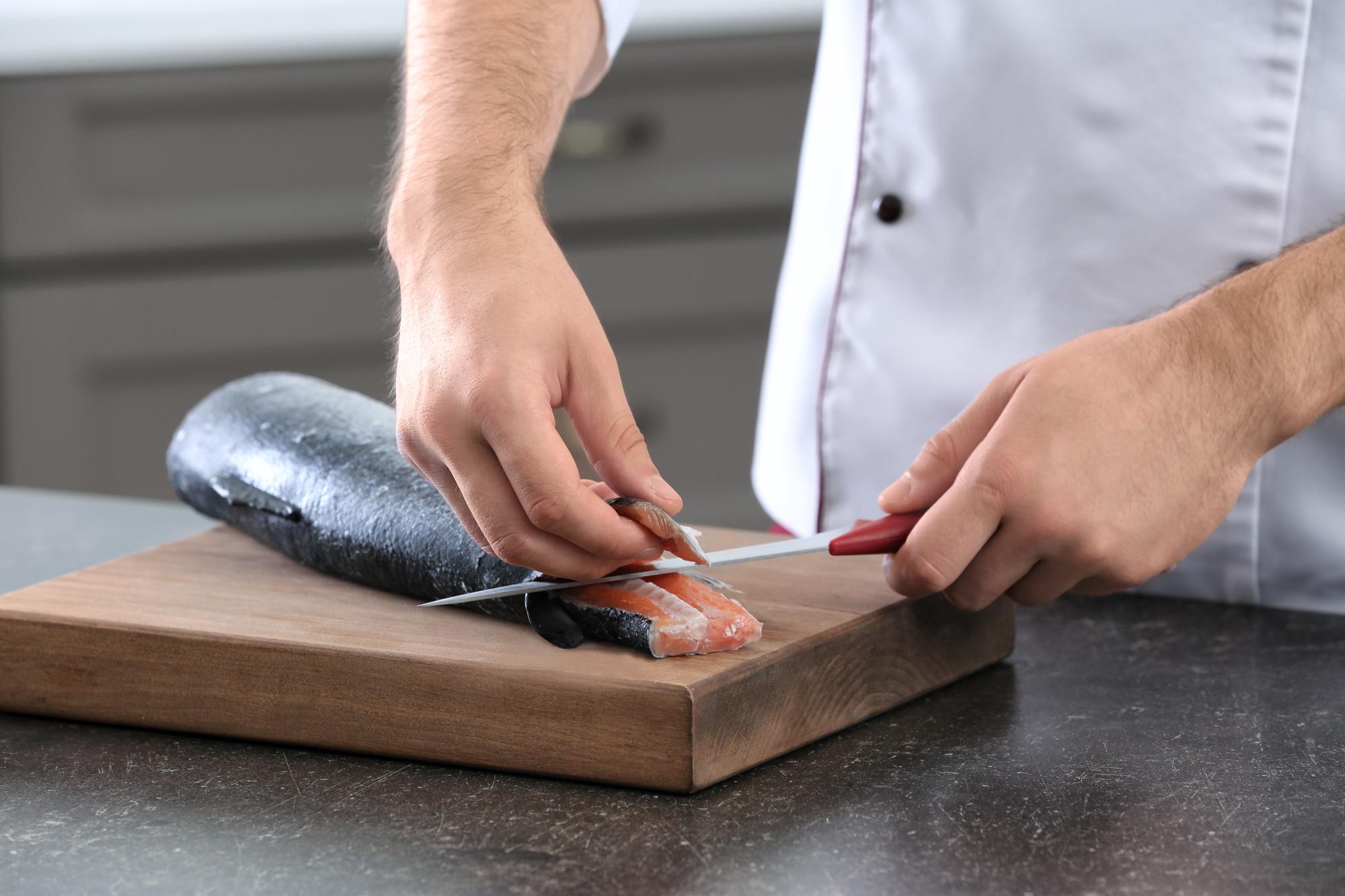 chef slicing cured fish